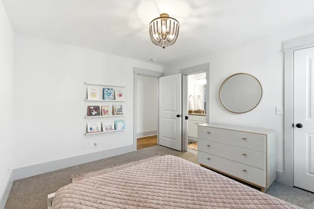 a bedroom with a bed and a mirror