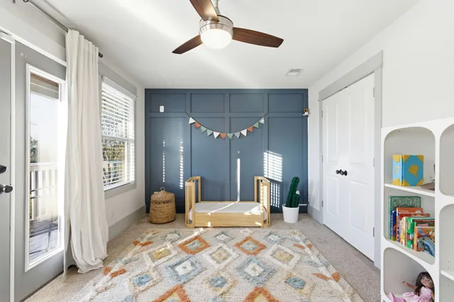 a bedroom with a bed cabinets and a window