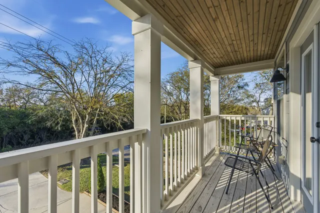 a view of a balcony with wooden floor