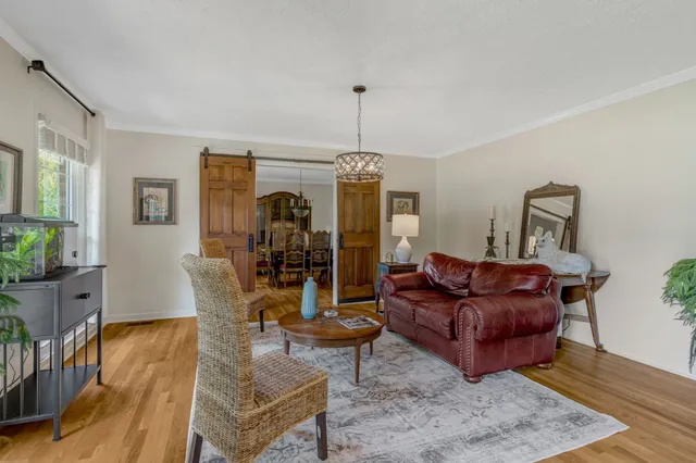 a living room with furniture fireplace and wooden floor