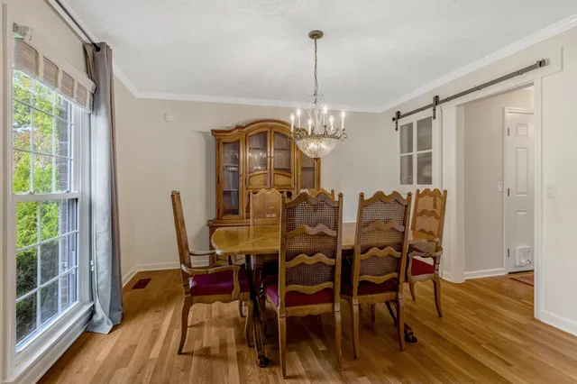 a view of a dining room with furniture window and wooden floor