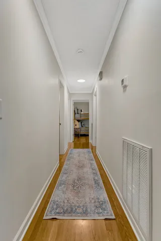 a view of hallway with wooden floor