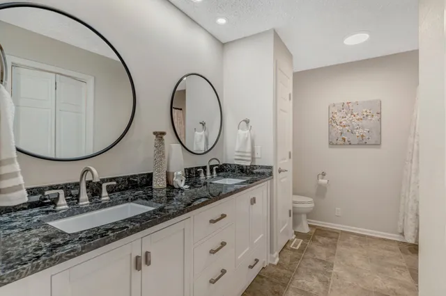 a bathroom with 2 sink and a mirror