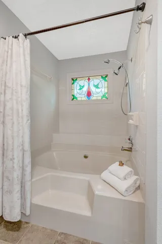 a bathroom with a shower and a bathtub