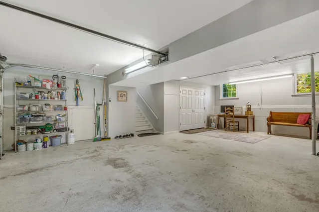 a view of a livingroom with workspace and furniture