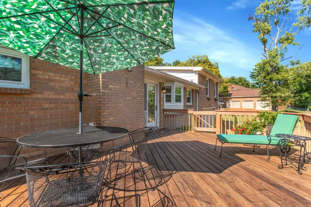 a view of balcony with wooden floor and outdoor seating