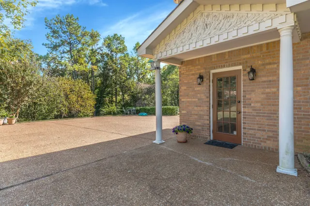 a view of a chair and table in the garden