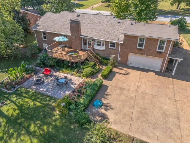 an aerial view of a house with a yard and lake view