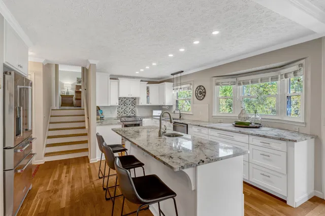 a kitchen with stainless steel appliances granite countertop counter space a sink and cabinets