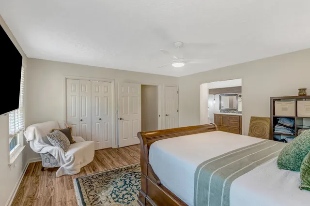 a bedroom with a bed and wooden floor