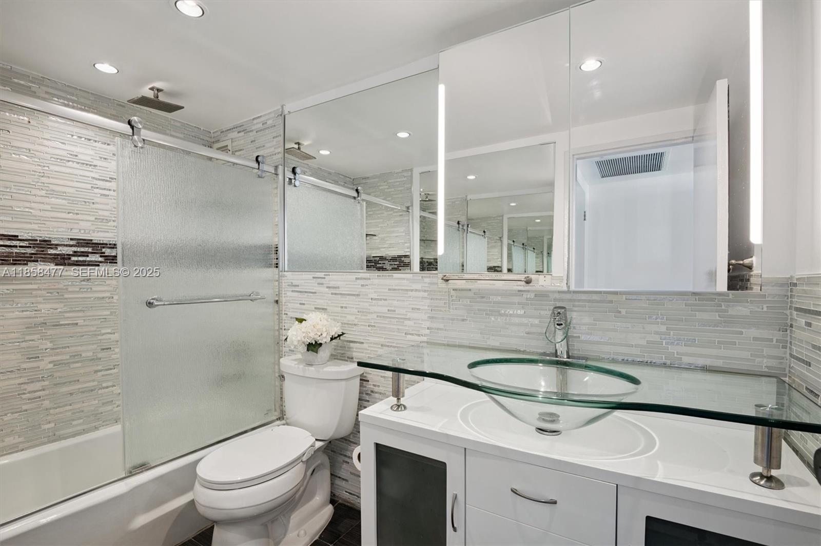5601 Collins Avenue, Unit 820 Miami Beach, FL 33140 - Photo 12 of 23 a bathroom with a sink toilet and shower