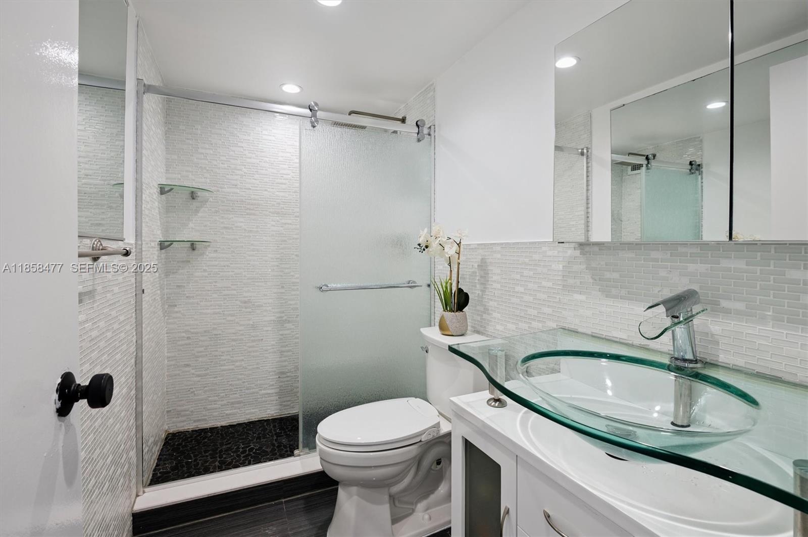 5601 Collins Avenue, Unit 820 Miami Beach, FL 33140 - Photo 15 of 23 a bathroom with a sink toilet and shower