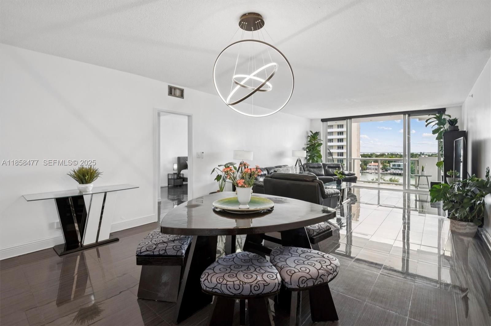 5601 Collins Avenue, Unit 820 Miami Beach, FL 33140 - Photo 2 of 23 a view of a dining room with furniture and wooden floor