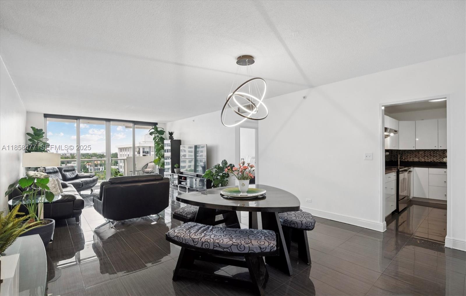 5601 Collins Avenue, Unit 820 Miami Beach, FL 33140 - Photo 6 of 23 a dining room with furniture a rug and a chandelier