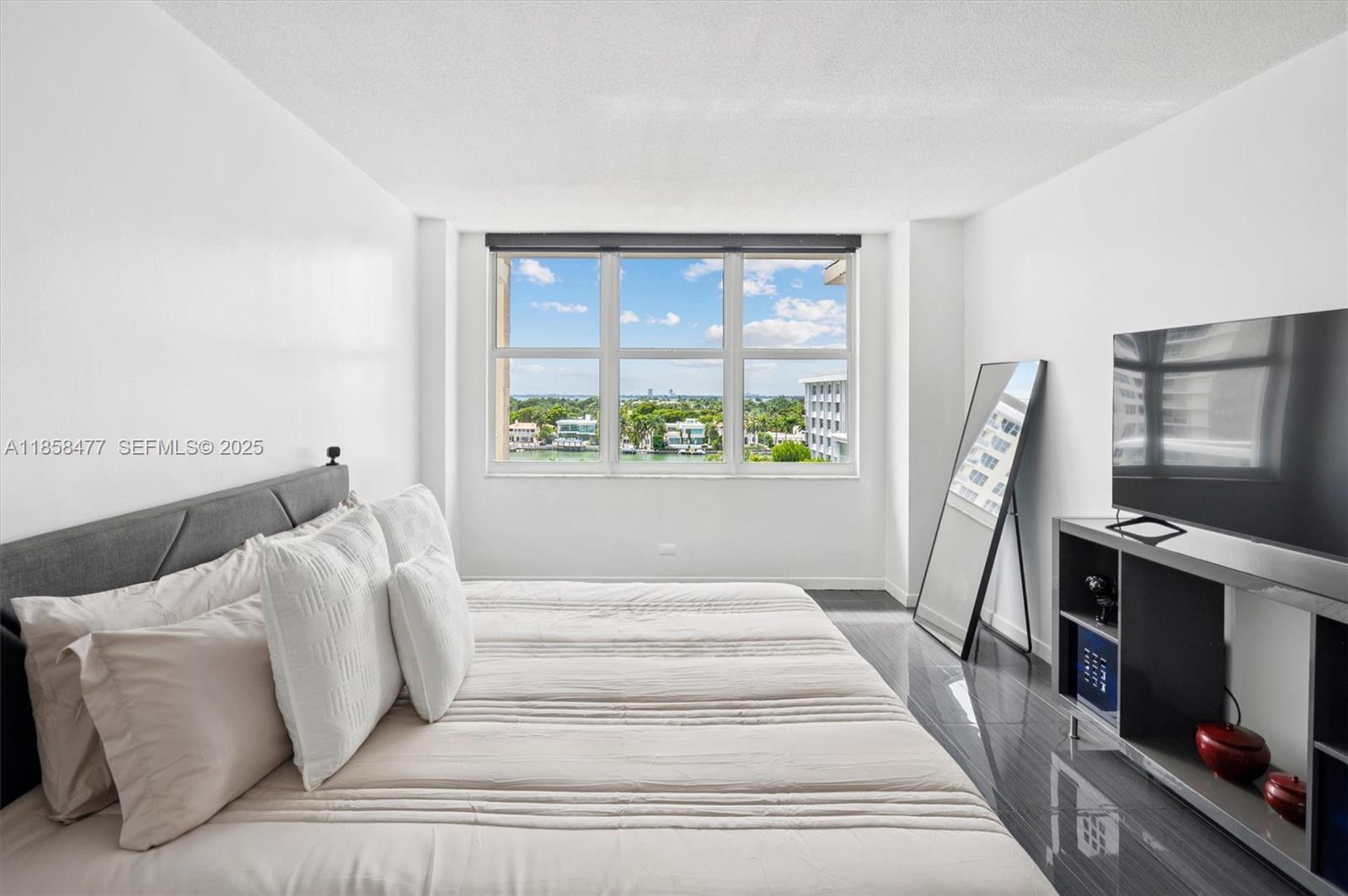 5601 Collins Avenue, Unit 820 Miami Beach, FL 33140 - Photo 10 of 23 a living room with furniture a flat screen tv and a fireplace