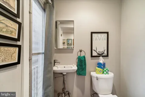 a bathroom with a toilet sink and mirror