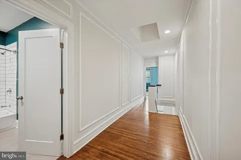 a view of a hallway with wooden floor