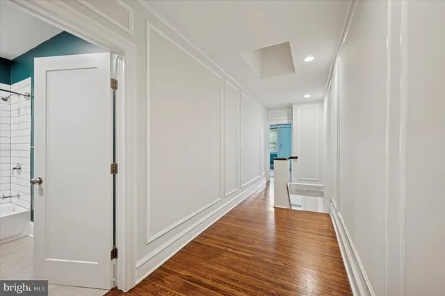 a view of a hallway with wooden floor