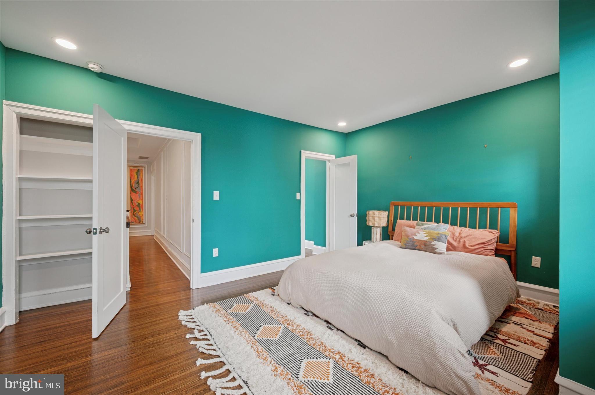 4935 Pine Street Philadelphia, PA 19143 - Photo 23 of 40 a bedroom with a large bed and a chandelier