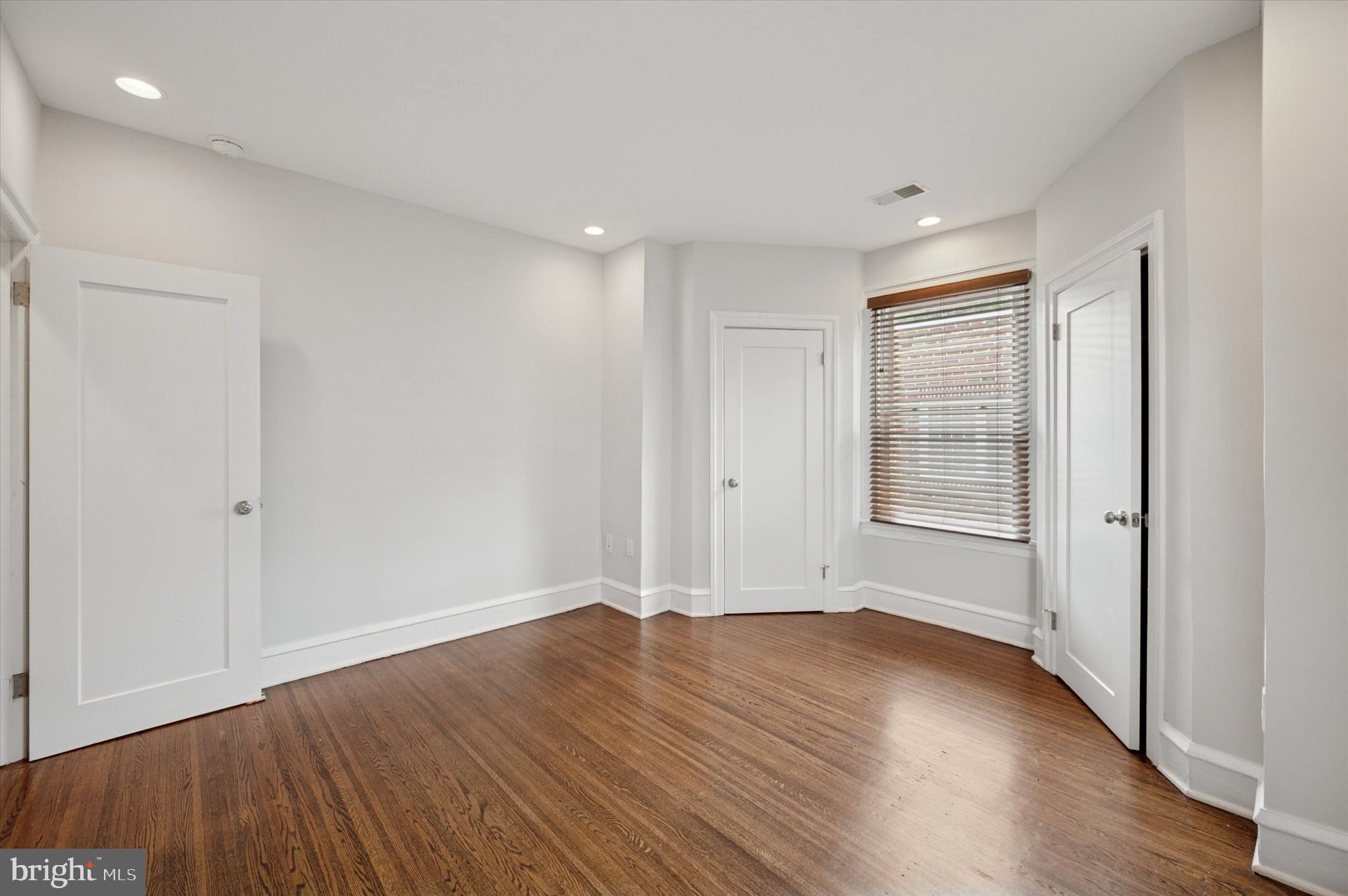 4935 Pine Street Philadelphia, PA 19143 - Photo 32 of 40 an empty room with wooden floor and windows