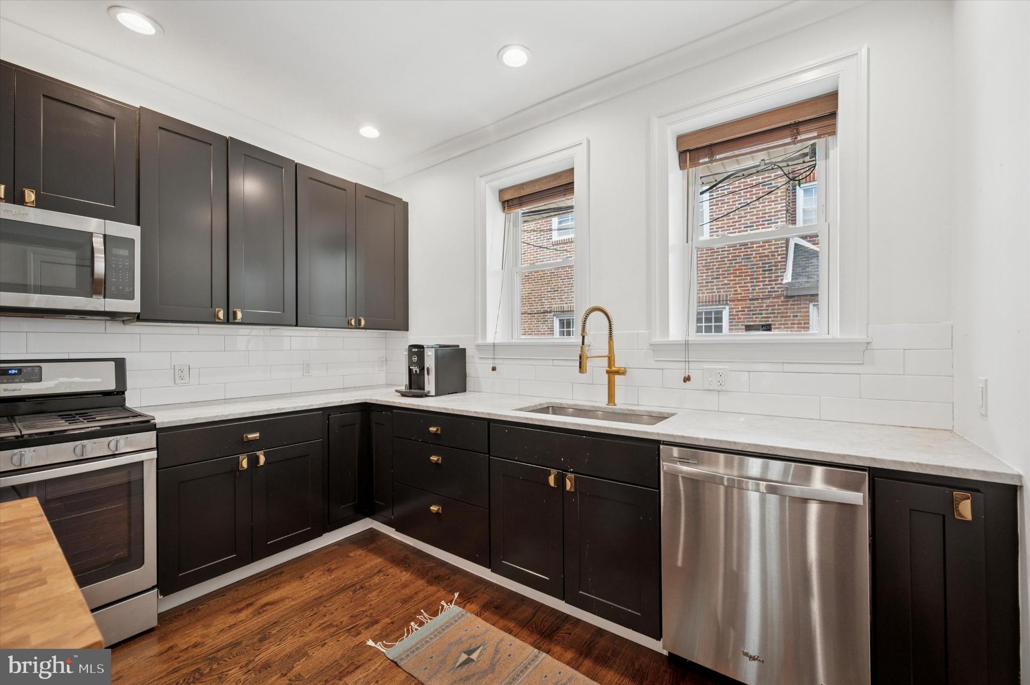 4935 Pine Street Philadelphia, PA 19143 - Photo 9 of 40 a kitchen with a sink stove and cabinets