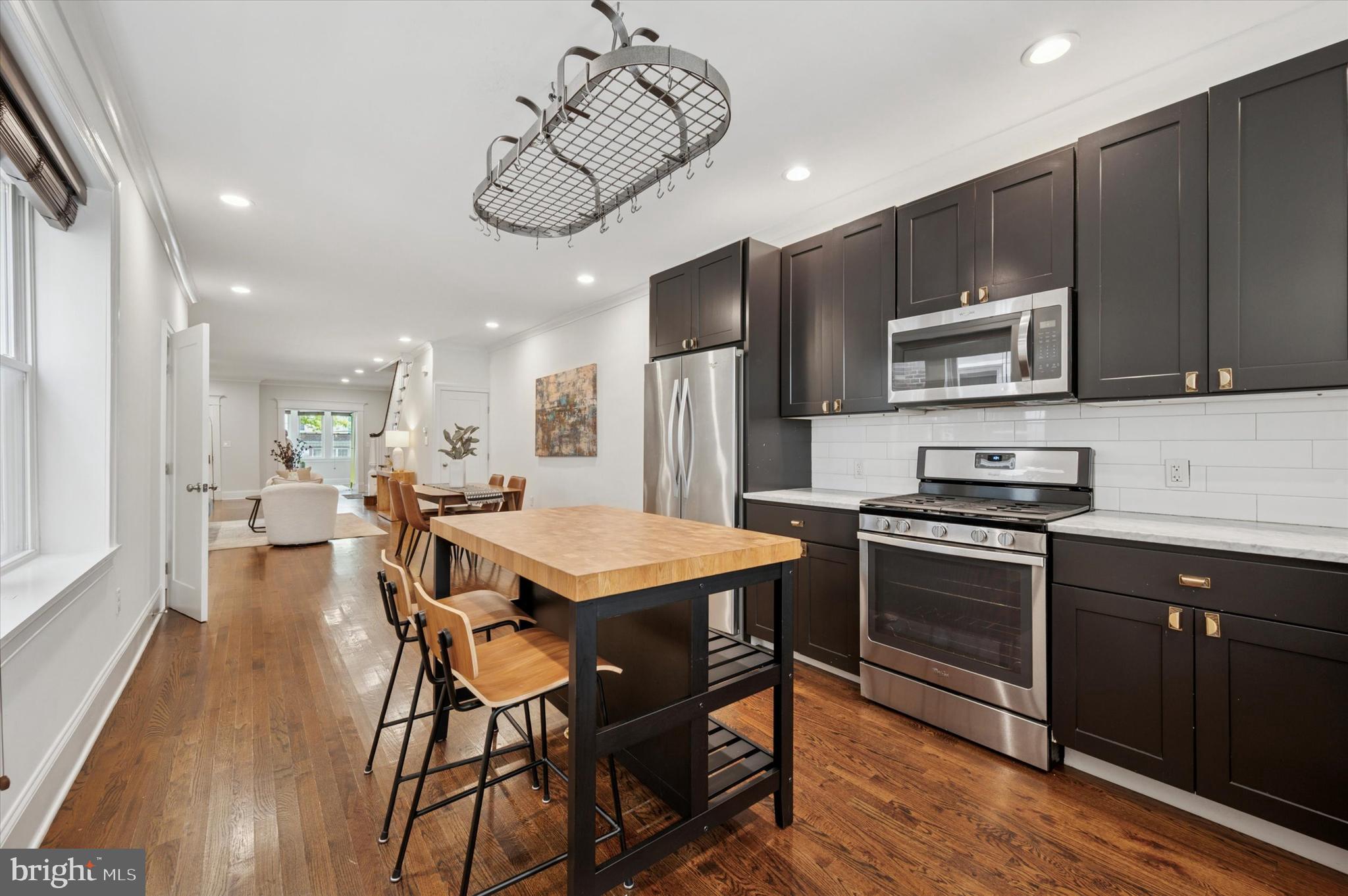 4935 Pine Street Philadelphia, PA 19143 - Photo 10 of 40 a kitchen with a table chairs microwave and cabinets