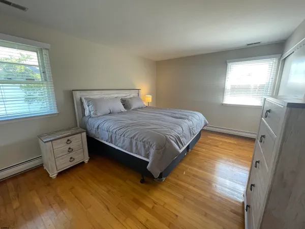 a bedroom with a bed dresser and a window