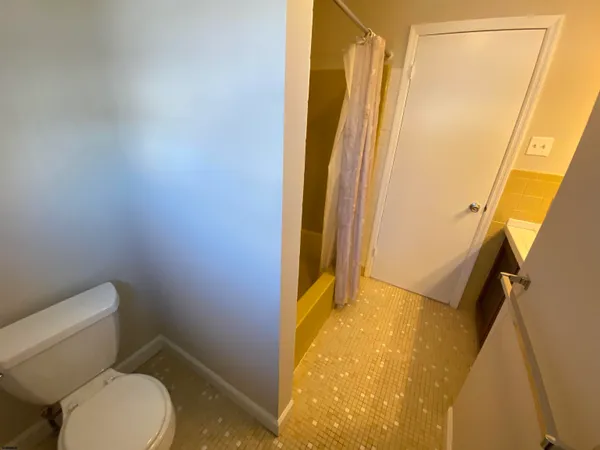 a bathroom with a toilet and shower
