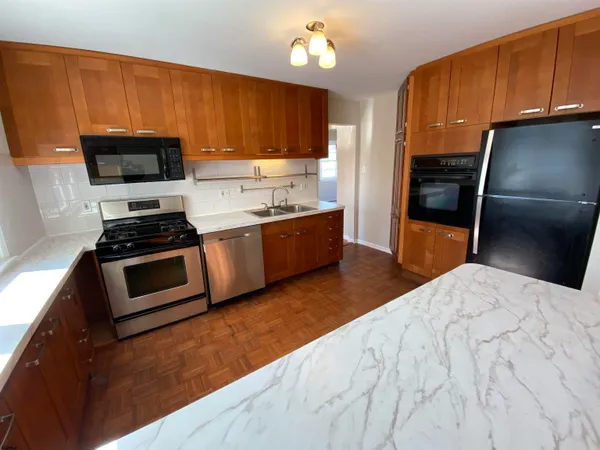 a kitchen with stainless steel appliances a stove a microwave and a refrigerator
