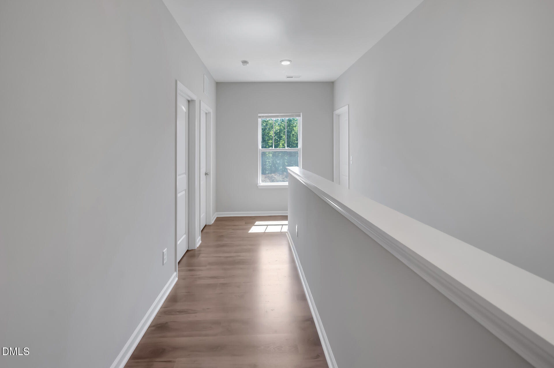 5406 Ripplebrook Drive Durham, NC 27712 - Photo 29 of 37 a view of a hallway with wooden floor