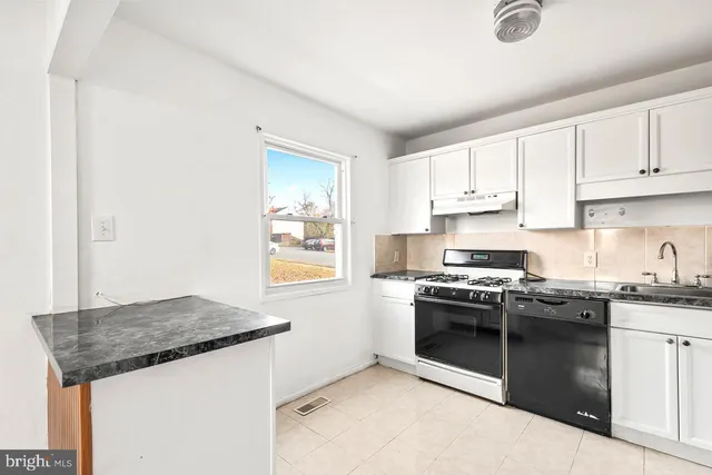 a kitchen with stainless steel appliances granite countertop a stove and a sink