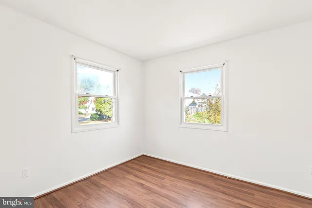 an empty room with windows and closet