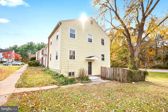 a view of a house with a yard and sitting area