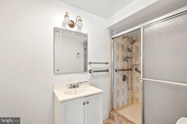 a bathroom with a sink a mirror and a shower