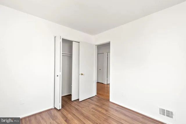 a view of hallway with wooden floor