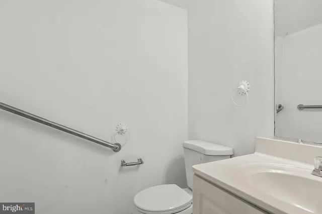 a white toilet sitting next to a bathroom sink