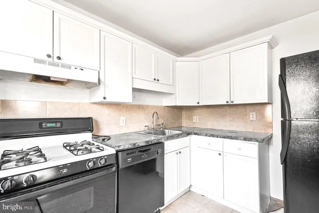 a kitchen with a stove a sink and a refrigerator