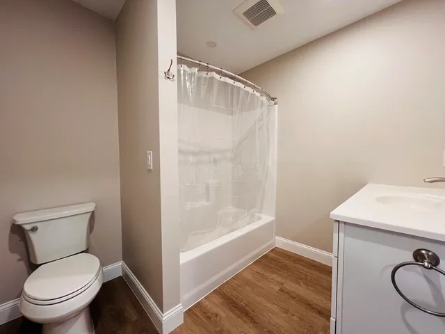 a bathroom with a toilet and a shower