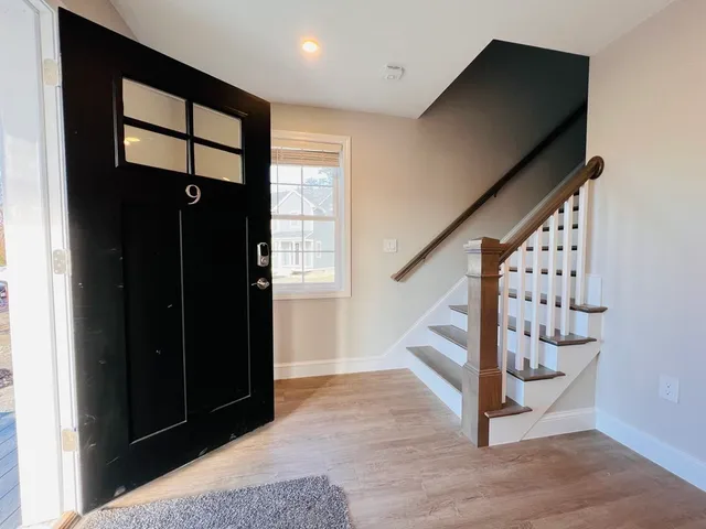 a view of entryway with wooden floor and stairs