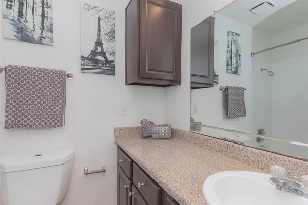 a bedroom with a bed and a potted plant