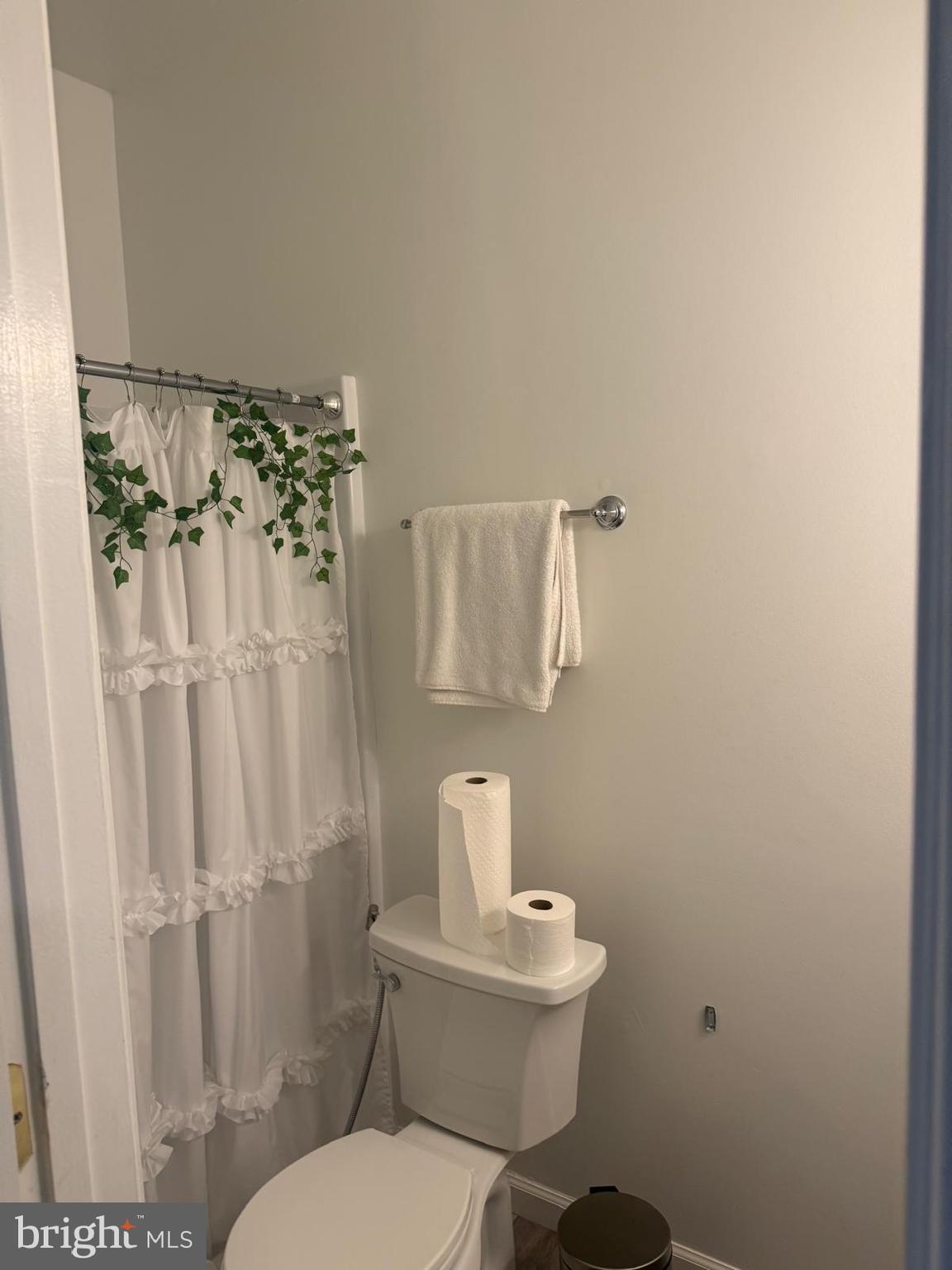 8469 Silverdale Road Lorton, VA 22079 - Photo 5 of 17 a white toilet sitting next to a shower curtain