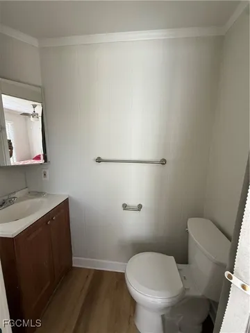 a white toilet sitting next to a bathroom sink