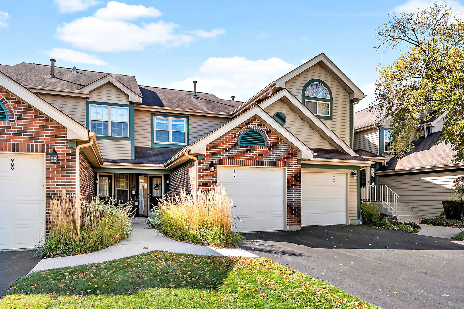 986 Ridgefield Lane Wheeling, IL 60090 - Photo 1 of 17 a front view of a house with a yard and garage