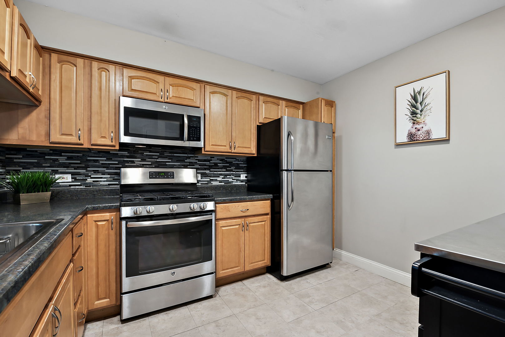 986 Ridgefield Lane Wheeling, IL 60090 - Photo 6 of 17 a kitchen with stainless steel appliances granite countertop a refrigerator stove and microwave