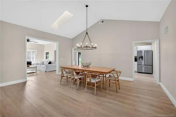 a view of a dining room with furniture wooden floor and chandelier