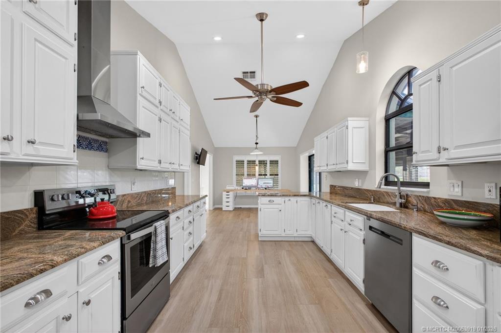 3211 Southeast Court Drive Stuart, FL 34997 - Photo 21 of 60 a kitchen with stainless steel appliances granite countertop a sink stove and cabinets