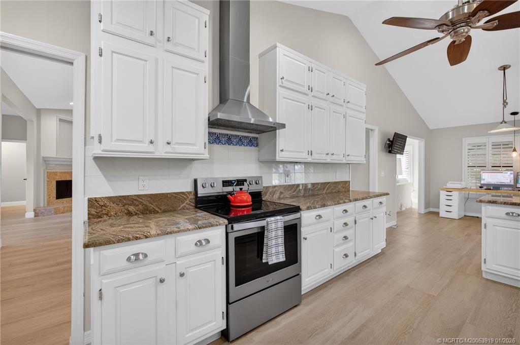 3211 Southeast Court Drive Stuart, FL 34997 - Photo 22 of 60 a kitchen with stainless steel appliances granite countertop a stove and white cabinets