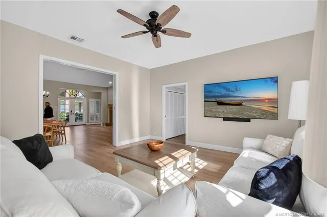 a large white kitchen with granite countertop a large window and a white counter top