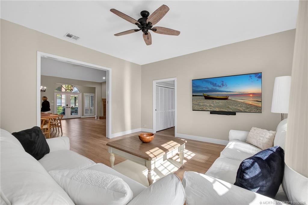 3211 Southeast Court Drive Stuart, FL 34997 - Photo 25 of 60 a living room with furniture ceiling fan and a rug