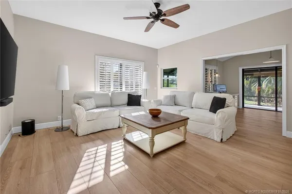 a large space with a large window and wooden floor